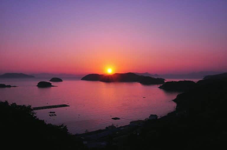 Sunset over islands and calm water